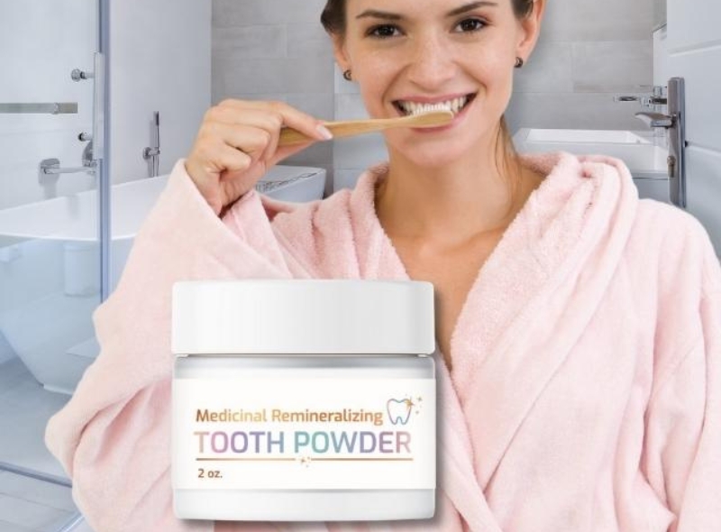 The Blend Remineralizing Tooth Powder in white  jar with woman in pink robe brushing her teeth